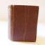 Hardcover red cover book with gold embossed title on spine