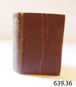 Hardcover red cover book with gold embossed title on spine