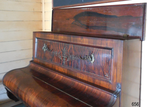 Underside of lid has a dark grain in the centre. It has brass hinges. The candlesticks are folded inwards.