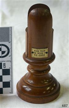 Turned timber card holder, polished, decorative, with a small plaque attached