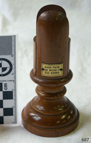 Turned timber card holder, polished, decorative, with a small plaque attached