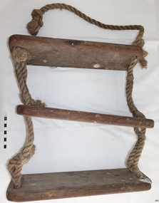 Three wooden rungs joined by lengths of knotted rope