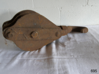 Metal becket block with tow sheaves and a hook