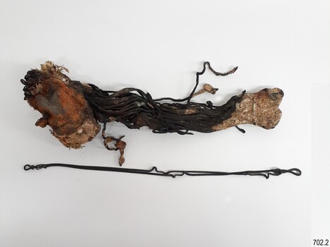 Watch chains within a conglomeration of sediment, with one chain separated from the mass