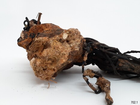 Conglomeration includes corroded chains, sand and other matter