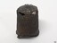 Metal flat-top dome, hollow inside. Surface is textured with dimples. It has some holes.