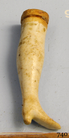 Ceramic doll]s leg, cream and beige, with shape of shoe on the end