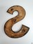 Brass nameplate is hollow underneath and has three round indentations for mounting