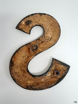 Brass nameplate is hollow underneath and has three round indentations for mounting