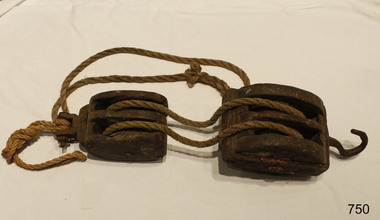 A Pair of wooden, two-sheave blocks assembled with robe between them