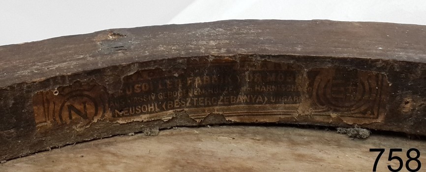 Label is flanked on each side by embossed stamps