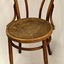 Round wooden seat has a pressed floral pattern