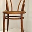 Wooden chair with rounded back and round patterned seat