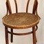 Round wooden seat has stamped floral pattern