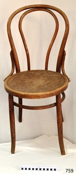 Round wooden seat has stamped floral pattern