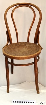 Round wooden seat has stamped floral pattern