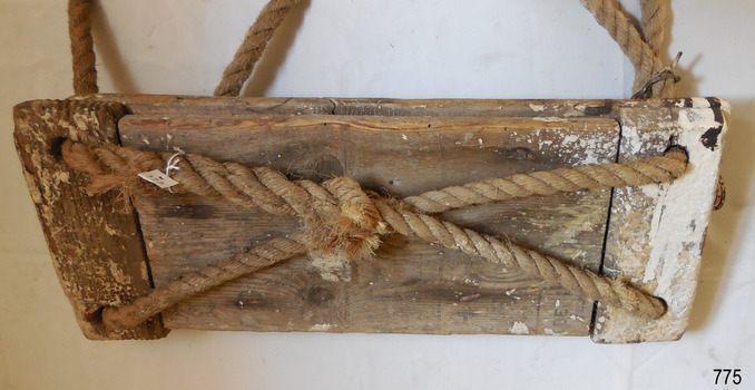 Two lengths of rope cross over underneath. Ends of each length are spliced together