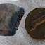 Base has bevelled edges and a portion is missing. Both base and top have holes in wood.