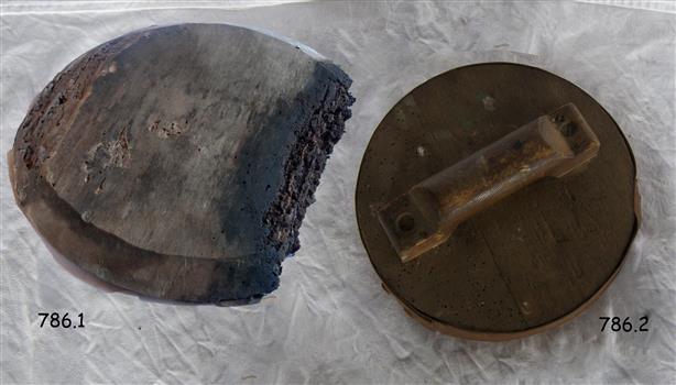 Base has bevelled edges and a portion is missing. Both base and top have holes in wood.