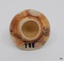 Round white ceramic lid with rough surface under glaze. Hollow inside.