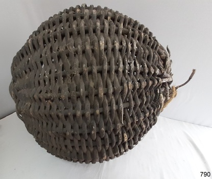 Woven cane has broken in places. It's black paint has worn off in areas. 