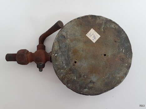 Metal of base has corroded in places. Two drilled holes are visible. The plate has been lacquered.