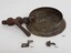 Round metal frame of gauge with pipe attached, plus two parts