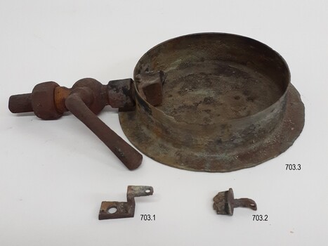 Round metal frame of gauge with pipe attached, plus two parts