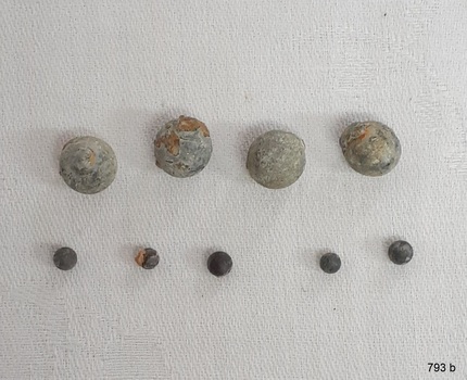 Four large and five small pieces of lead shot