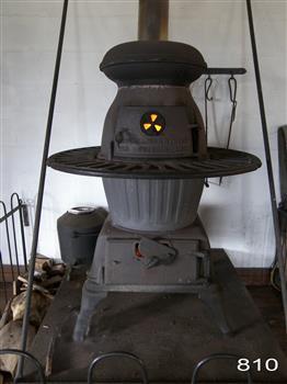 A large pot-belly stove made of grey and black coloured cast iron