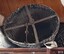 Base of cone has two crossed metal bars with a metal loop attached to the centre