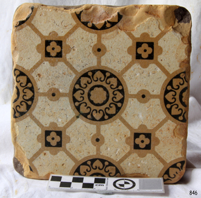 Square cream floor tile with coloured geometric pattern of round and square motifs and diagonal lines
