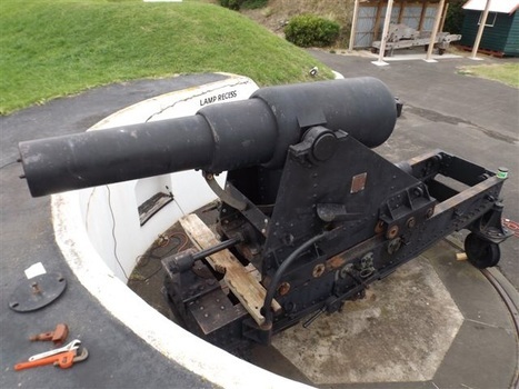 Cannon with tools around it and protective hill behind it