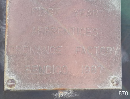 Brass metal restoration plate with stamped characters.