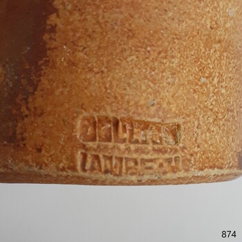 Maker's mark is stamped into the bottom edge of the bottle