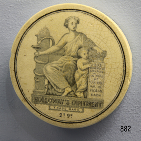 Cream coloured ceramic lid with Trade Mark; image of adult and child and text