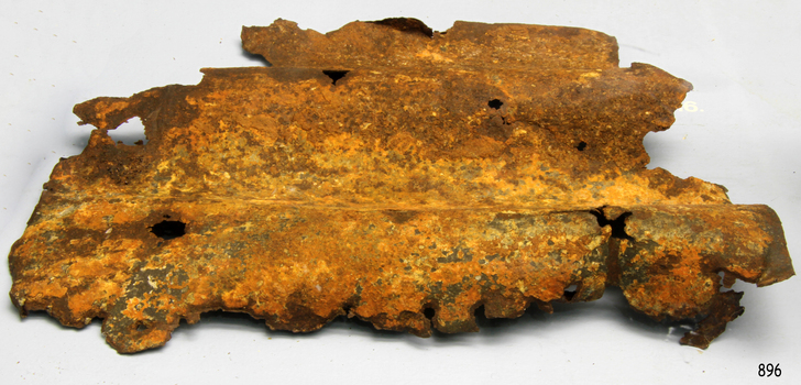 Corrugated iron is still recognisable by its shape but has suffered corrosion