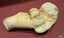 Small piece has smooth edges and brown, green and yellow areas of colour