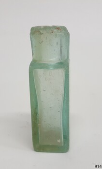 Side view of pill bottle shows varying thickness of glass