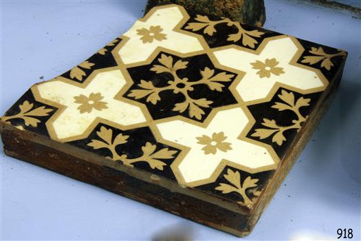 Square floor time with dark brown background and beige and white floral and geometric pattern