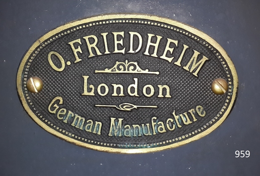 Oval metal plate with embossed text