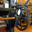 The wheel turns the cogs on the gear. The front hand winds the bed front to back