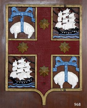 Cast metal coat of arms, panel with emblems of sheep , sailing shps and stars