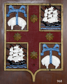 Cast metal coat of arms, panel with emblems of sheep , sailing shps and stars