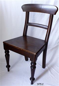 Dark brown wooden chair with curved back and flat seat