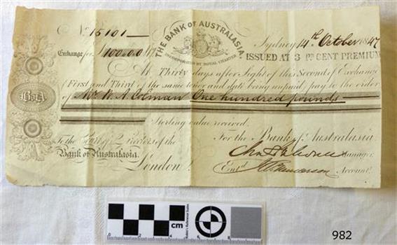 Banknote has printed text, insignia and images, plus handwritten text in black ink