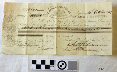 Banknote has printed text, insignia and images, plus handwritten text in black ink