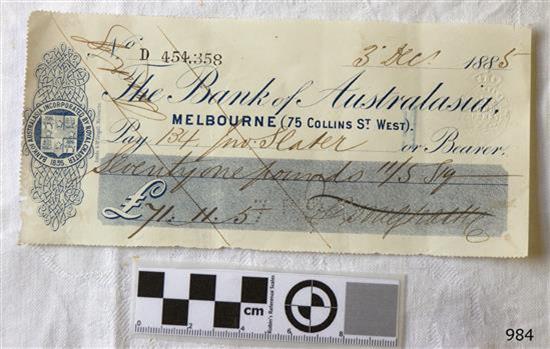 Cheque printed in blue with Bank's insignia and watermark. Stamped number. Handwritten details.