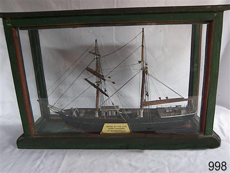 Ship model with two masts in a timber framed glass display case.