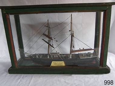 Ship model with two masts in a timber framed glass display case.